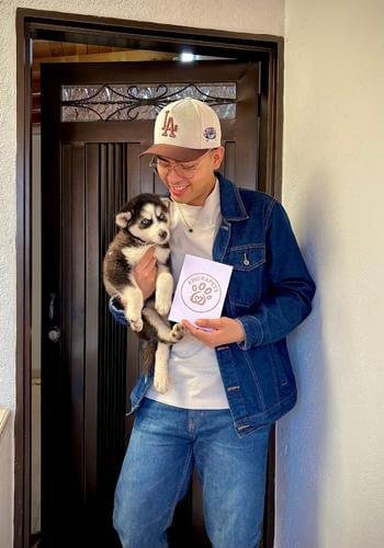 Familia feliz recibiendo su cachorro Husky Siberiano de AmoraPets en Colombia